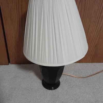 Cushioned wooden bar stool small lamp and an alarm clock