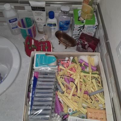 Box of hair curlers, nail care kit, soaps, lotions, Kleenex, perfumes, and brass bathtub soap holder