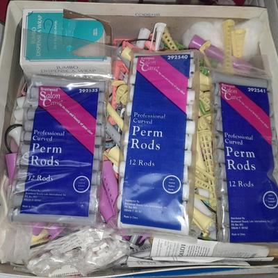 Box of hair curlers, nail care kit, soaps, lotions, Kleenex, perfumes, and brass bathtub soap holder