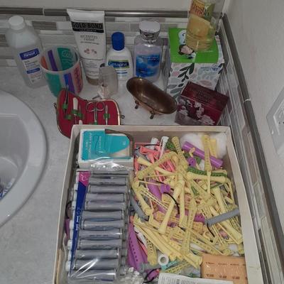 Box of hair curlers, nail care kit, soaps, lotions, Kleenex, perfumes, and brass bathtub soap holder