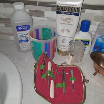Box of hair curlers, nail care kit, soaps, lotions, Kleenex, perfumes, and brass bathtub soap holder