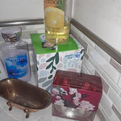 Box of hair curlers, nail care kit, soaps, lotions, Kleenex, perfumes, and brass bathtub soap holder
