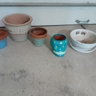 Several decorative flower / plant pots and small roll of tree wrap