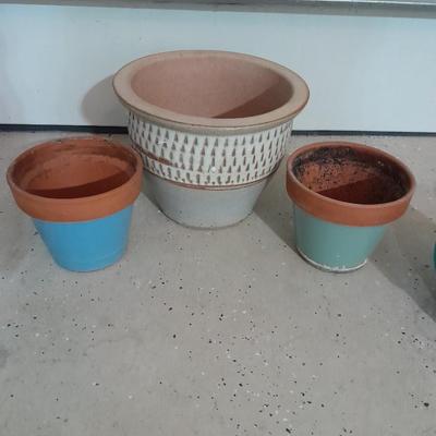 Several decorative flower / plant pots and small roll of tree wrap