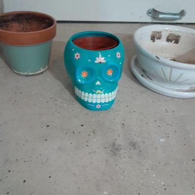 Several decorative flower / plant pots and small roll of tree wrap