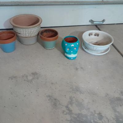 Several decorative flower / plant pots and small roll of tree wrap