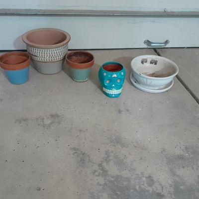 Several decorative flower / plant pots and small roll of tree wrap