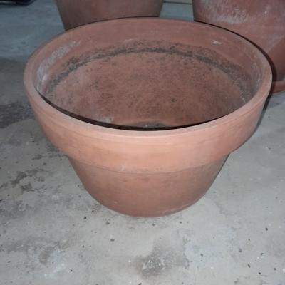 Three larger sized terracotta plant / flowerpots and a glass vase