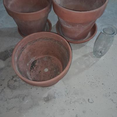 Three larger sized terracotta plant / flowerpots and a glass vase