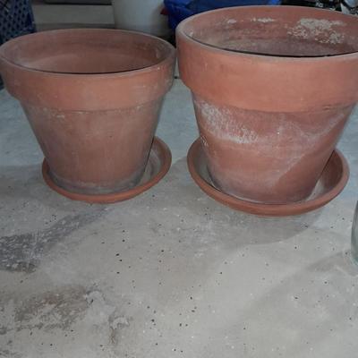 Three larger sized terracotta plant / flowerpots and a glass vase