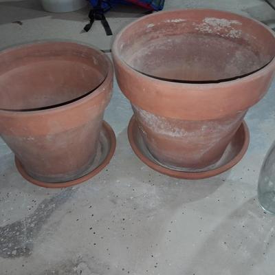 Three larger sized terracotta plant / flowerpots and a glass vase