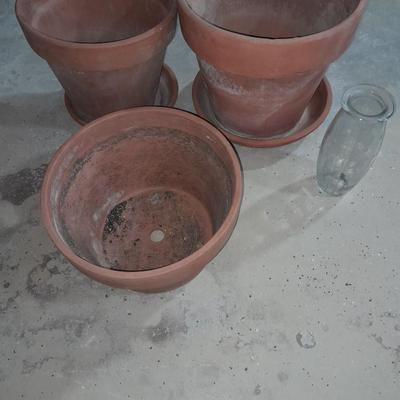 Three larger sized terracotta plant / flowerpots and a glass vase
