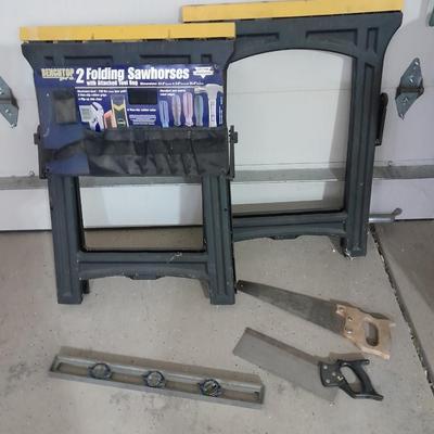 Two new folding sawhorses with attached tool bag, handsaws and a level