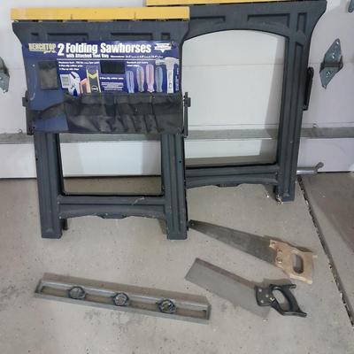 Two new folding sawhorses with attached tool bag, handsaws and a level