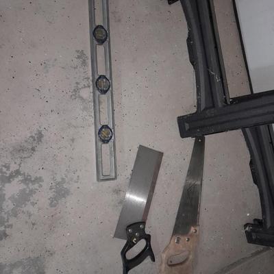 Two new folding sawhorses with attached tool bag, handsaws and a level