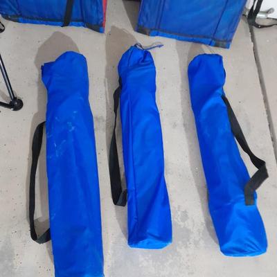 Four folding portable chairs and two stadium seat cushions