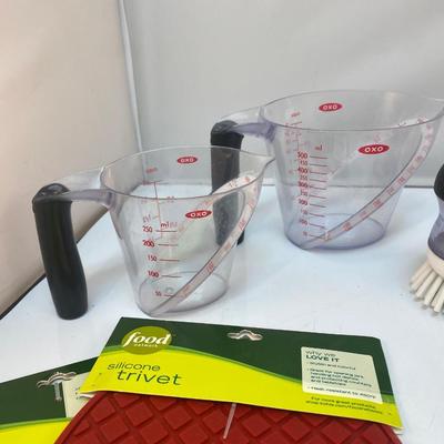 Miscellaneous Mix of Kitchen Items Potholders Trivet Measuring Cups