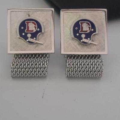 Denver Bronco's cuff links, Bronco's Kodak official film of NFL hat pin, and a black leather wallet