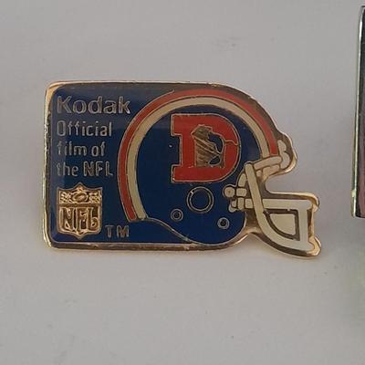 Denver Bronco's cuff links, Bronco's Kodak official film of NFL hat pin, and a black leather wallet