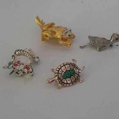 Four Fun and fancy hat pins, Roadrunner, Turtle, Frog, and a Clown