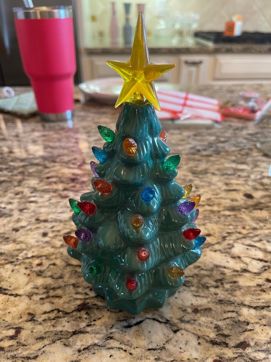 Ceramic Christmas tree. Lights up. Needs battery. 8” tall