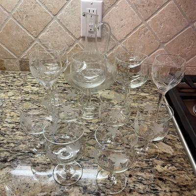 Beautiful wine pitcher with 4 wine glasses, 2 smaller wine glasses, and 6 smaller wine glasses.