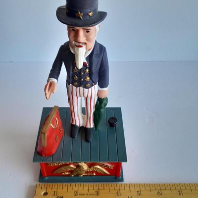 Uncle Sam coin bank and wooden coin bank with movement