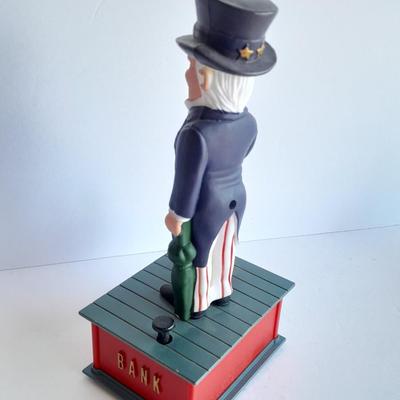 Uncle Sam coin bank and wooden coin bank with movement