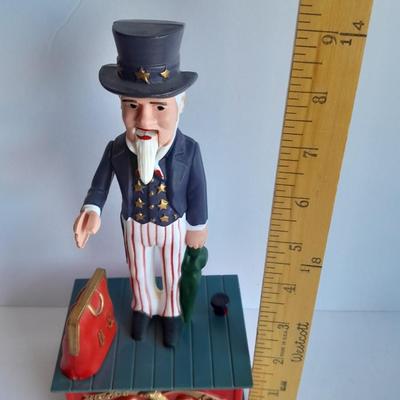 Uncle Sam coin bank and wooden coin bank with movement