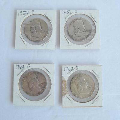 Four Franklin Half Dollar coins 1952P, 1954S, 1962D, and 1963D