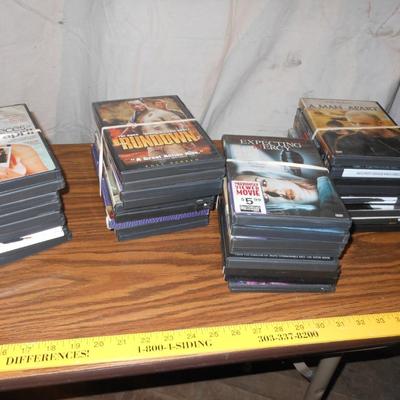 LARGE VARIETY OF MOVIES ON DVD'S AND A STAND