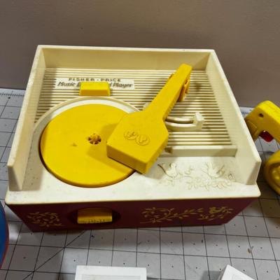 Mixed Lot Fisher Price Action Films and Record Player,  Chain Saw and a shape Ball  