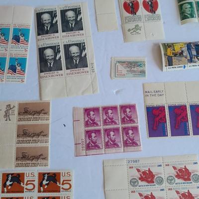 Unused postage stamp collection with Color Treasury of Stamp Collecting book.