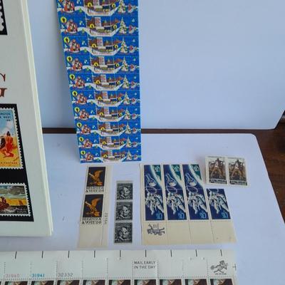 Unused postage stamp collection with Color Treasury of Stamp Collecting book.