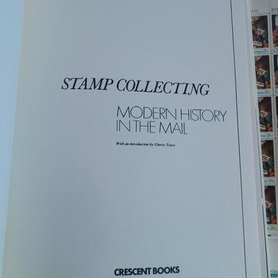 Unused postage stamp collection with Color Treasury of Stamp Collecting book.