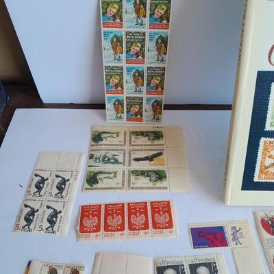 Unused postage stamp collection with Color Treasury of Stamp Collecting book.