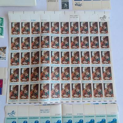 Unused postage stamp collection with Color Treasury of Stamp Collecting book.