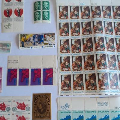 Unused postage stamp collection with Color Treasury of Stamp Collecting book.