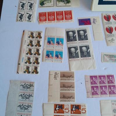 Unused postage stamp collection with Color Treasury of Stamp Collecting book.