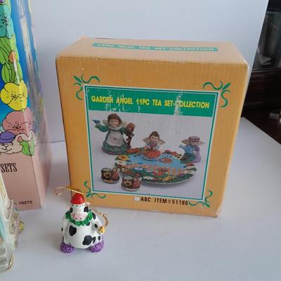 Collectibles Tic Tac Toe, illuminated church, cow ornament, otter snow globe and Hummingbird tea set