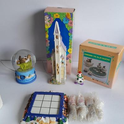 Collectibles Tic Tac Toe, illuminated church, cow ornament, otter snow globe and Hummingbird tea set