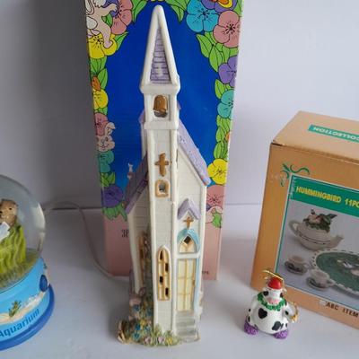 Collectibles Tic Tac Toe, illuminated church, cow ornament, otter snow globe and Hummingbird tea set