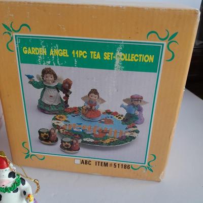 Collectibles Tic Tac Toe, illuminated church, cow ornament, otter snow globe and Hummingbird tea set