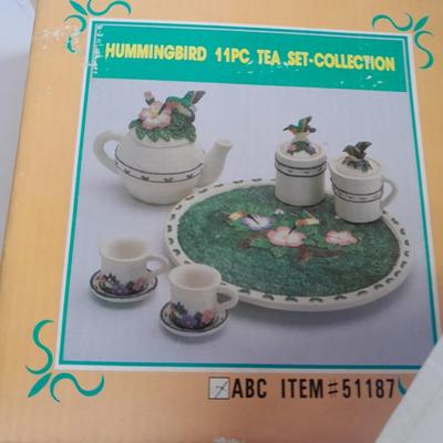 Collectibles Tic Tac Toe, illuminated church, cow ornament, otter snow globe and Hummingbird tea set
