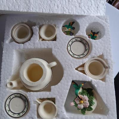 Collectibles Tic Tac Toe, illuminated church, cow ornament, otter snow globe and Hummingbird tea set