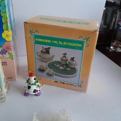 Collectibles Tic Tac Toe, illuminated church, cow ornament, otter snow globe and Hummingbird tea set