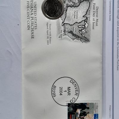 Two unopened 2004 United States Louisianna Purchase Five-Cent coins and a Lincoln - Kennedy Penny