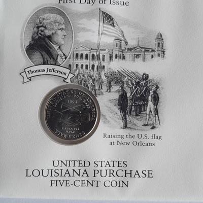 Two unopened 2004 United States Louisianna Purchase Five-Cent coins and a Lincoln - Kennedy Penny