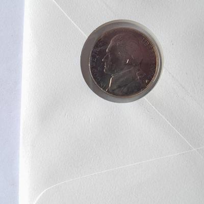 Two unopened 2004 United States Louisianna Purchase Five-Cent coins and a Lincoln - Kennedy Penny