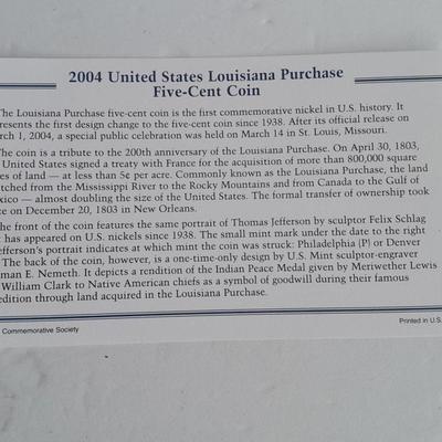 Two unopened 2004 United States Louisianna Purchase Five-Cent coins and a Lincoln - Kennedy Penny